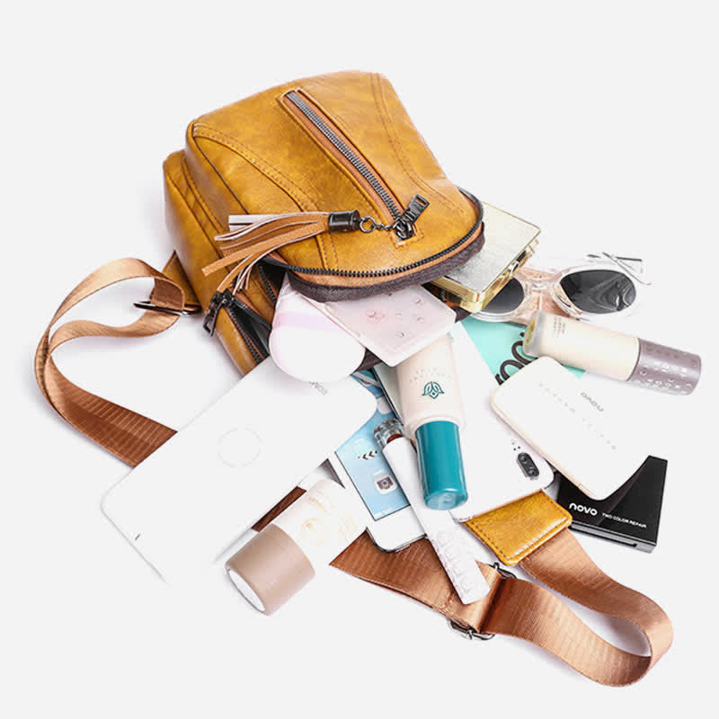 Camel brown PU leather sling bag shown with phone, sunglasses, cosmetics, and small essentials