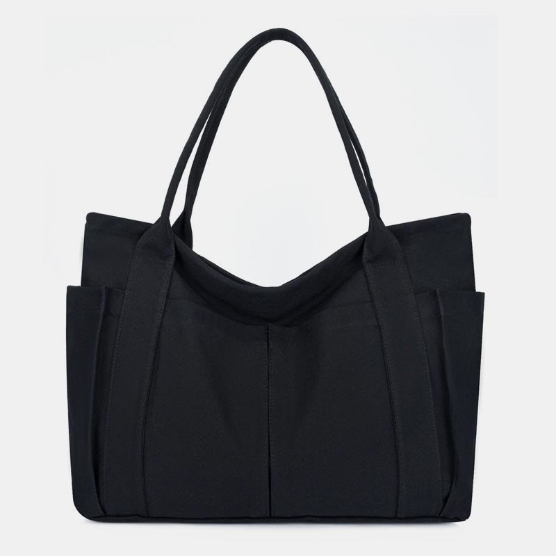 Black canvas tote bag with canvas handles and zipper closure