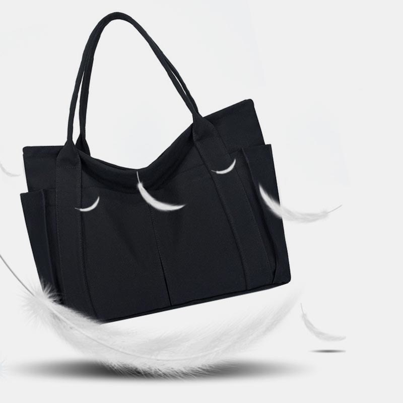 Black large canvas tote bag with canvas handles and zipper closure