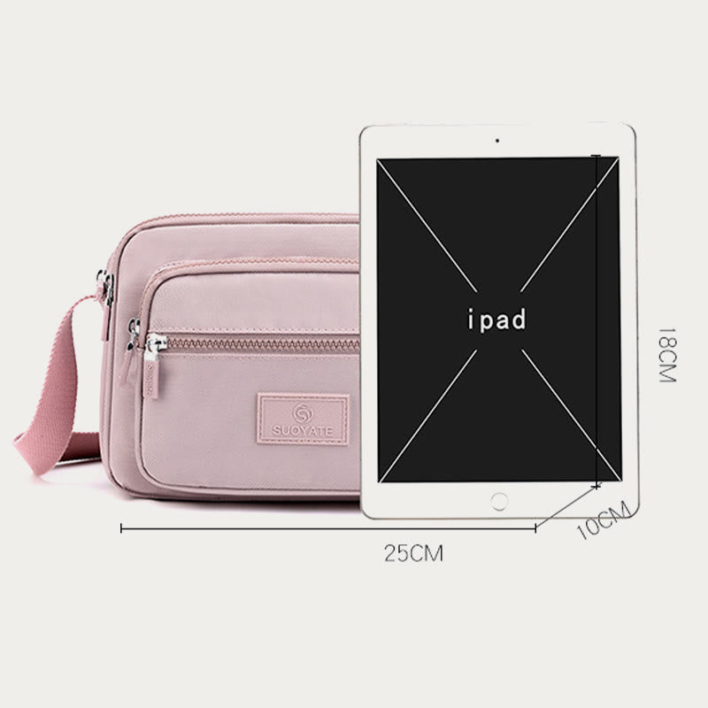 Light pink four-zip crossbody bag dimensions with tablet size reference