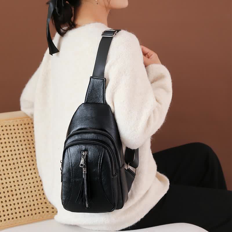 Black PU leather sling bag worn over the shoulder