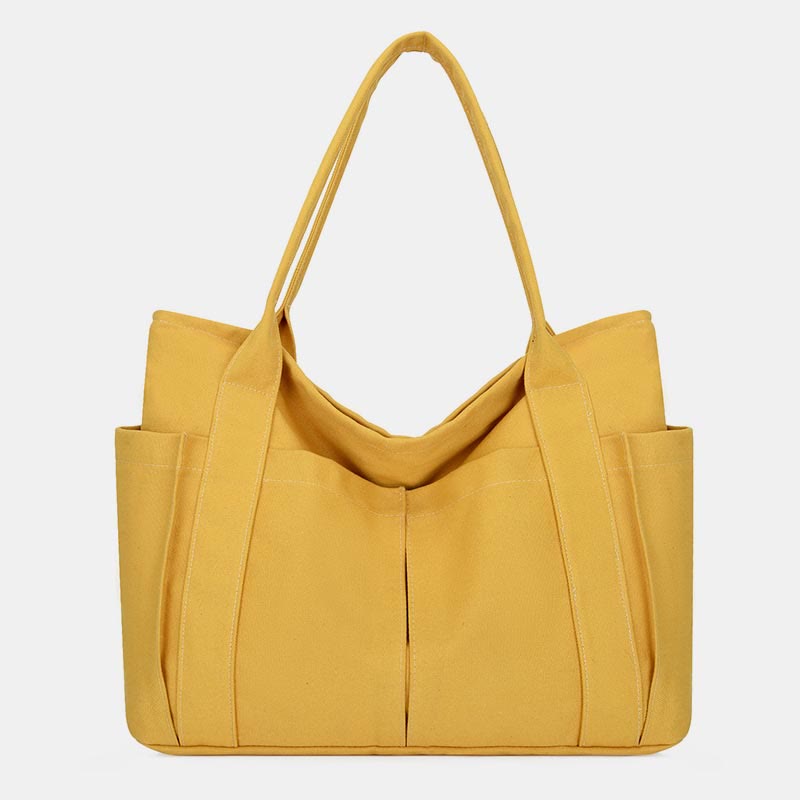 Yellow canvas tote bag with canvas handles and zipper closure