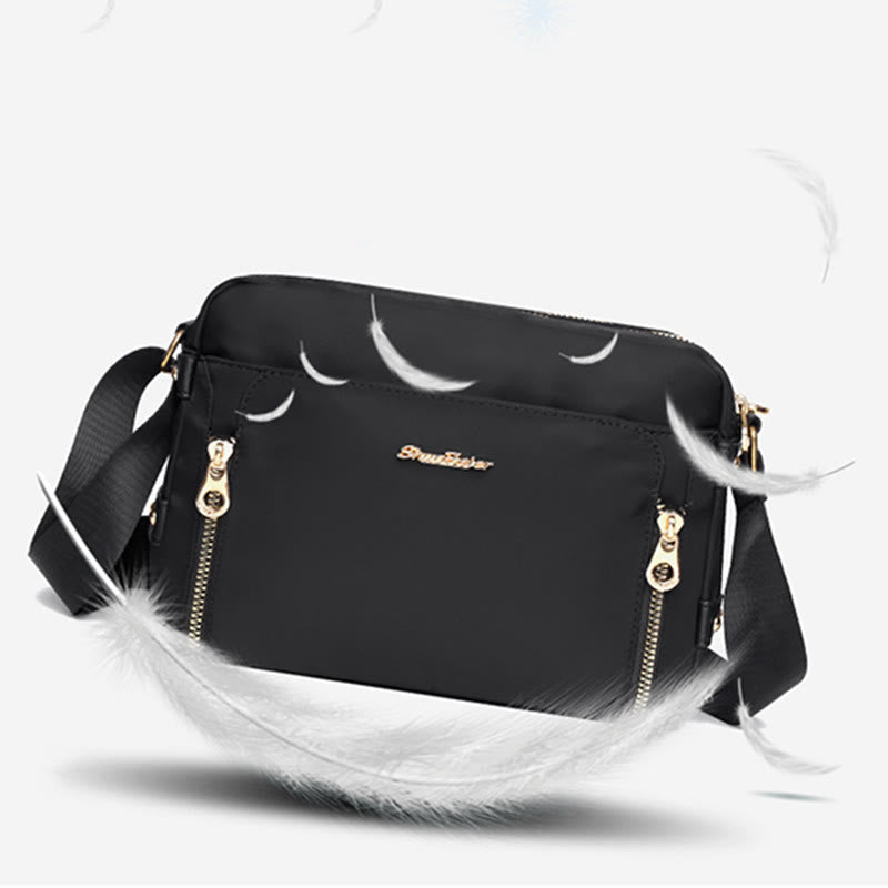 Black waterproof nylon crossbody bag with adjustable strap