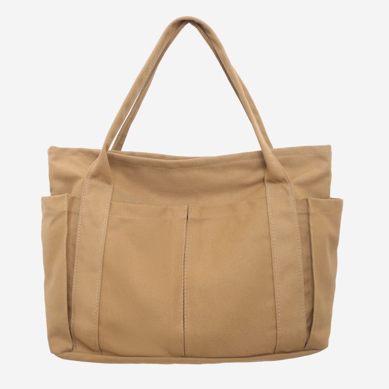 Beige canvas tote bag with canvas handles and zipper closure