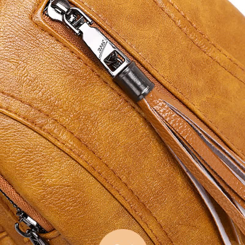 Camel brown PU leather sling bag zipper pull and tassel close-up