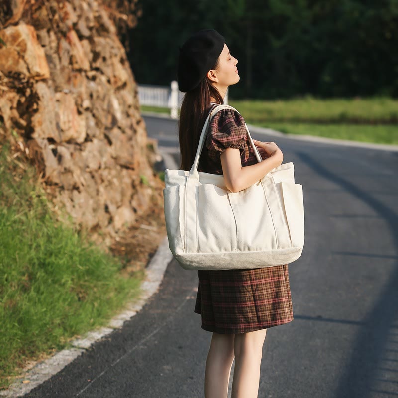 White large canvas tote bag carried outdoors