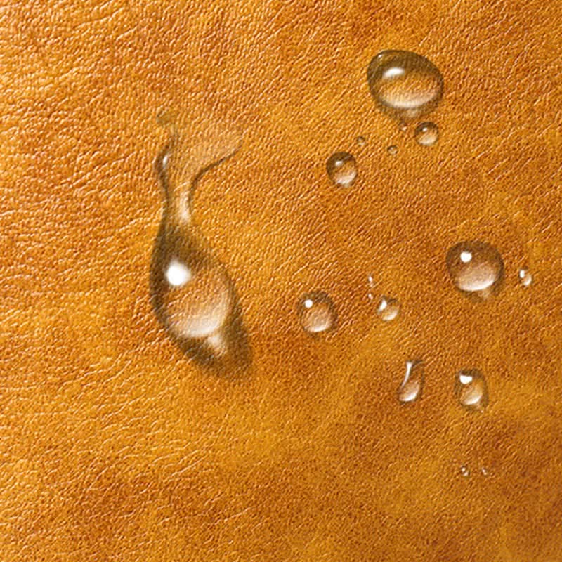 Water droplets on camel brown PU leather surface detail