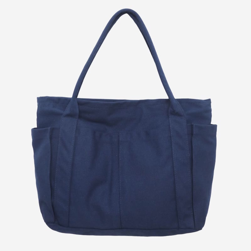 Navy blue canvas tote bag with canvas handles and zipper closure