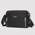 Black waterproof nylon crossbody bag angled front view