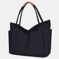 Black canvas tote bag with PU leather handles and zipper closure