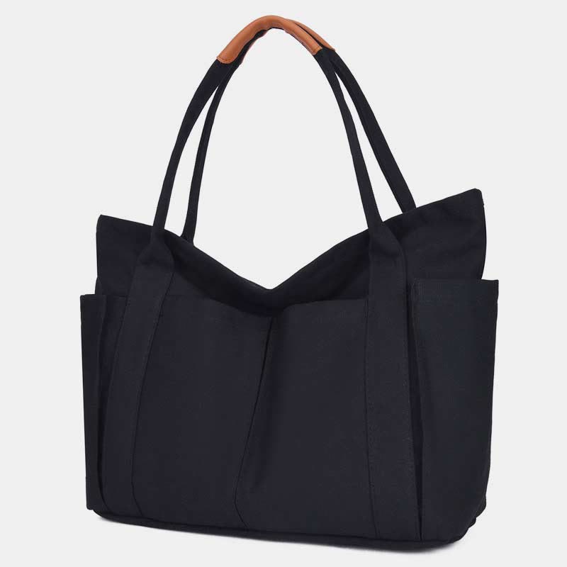 Black canvas tote bag with PU leather handles and zipper closure