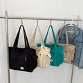 Black, ivory, mint green, and tan canvas tote color options