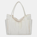 White canvas tote bag with canvas handles and zipper closure