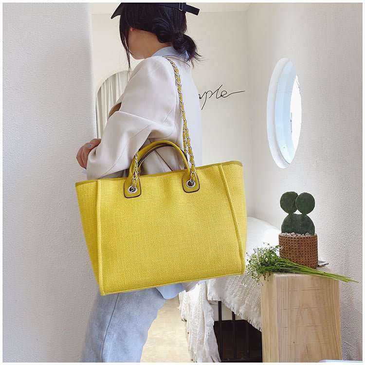 Women's canvas bucket crossbody bag with chain strap