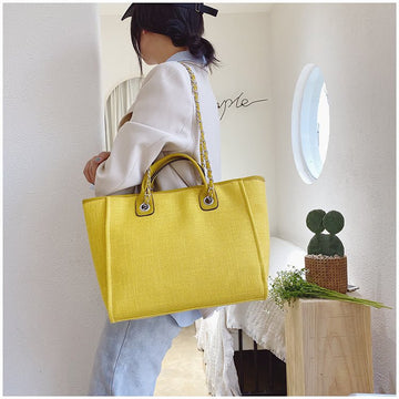 Women's canvas bucket crossbody bag with chain strap