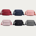 Six color options for the four-zip nylon crossbody bag