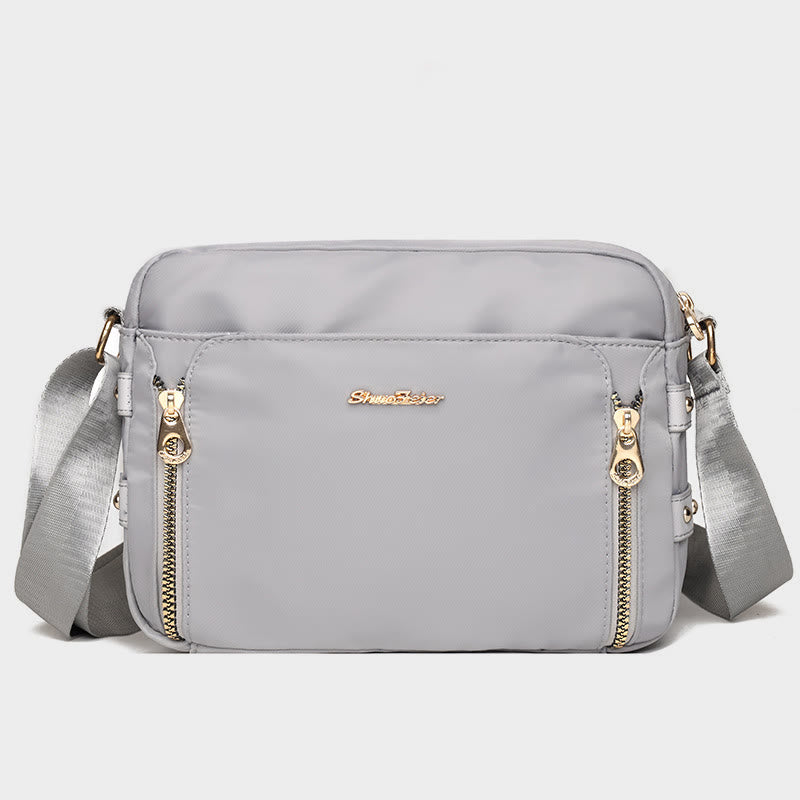 Light gray waterproof nylon crossbody bag for women with adjustable strap