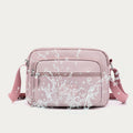 Light pink four-zip nylon crossbody bag front pocket detail