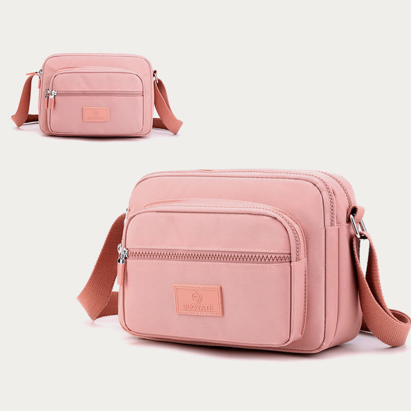 Light pink four-zip lightweight nylon crossbody bag for women