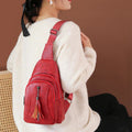Red PU leather sling bag worn over the shoulder